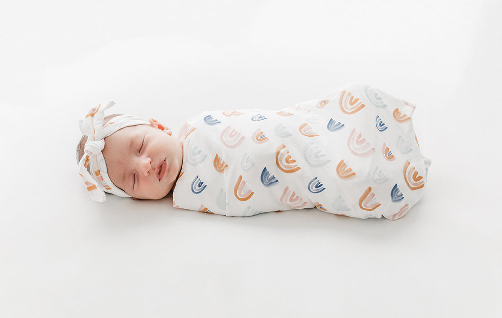 A baby wrapped in our Nest-Swaddle Blanket