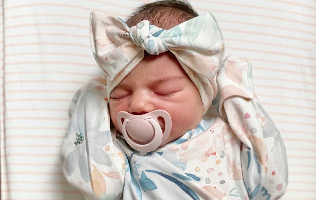 Newborn Wearing A Newborn Nest Gown